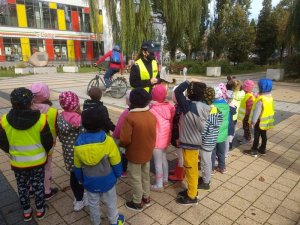Policjantka tłumaczy dzieciom zasady bezpiecznego poruszania się po drodze